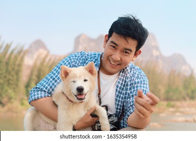 Happy Asian Man With His Dog Take A Rest At Outdoor.