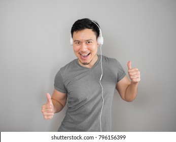 Happy Asian Man Listens To Music And Funny Dance.