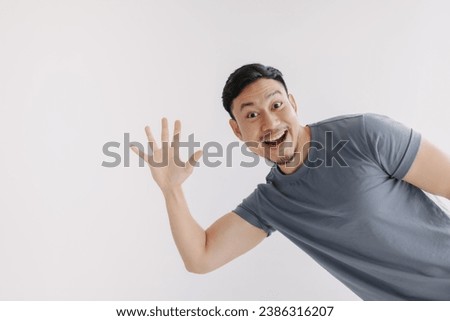 Happy asian man pop out for greeting and say hi, stand isolated on white.