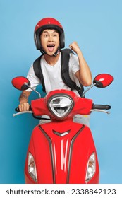 Happy Asian man in red helmet rides on red motor bike, smiling and enjoying life, delivery concept