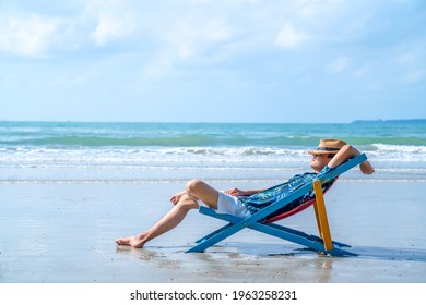 Happy Asian man relax and enjoy outdoor lifestyle travel ocean on summer holiday vacation. Handsome guy relaxing and sleeping on sunbed at tropical island beach in sunny day. People and nature concept - Powered by Shutterstock