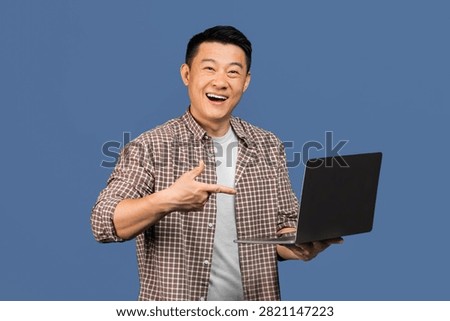 Happy Asian Man Smiling While Pointing At Laptop, Business Concept