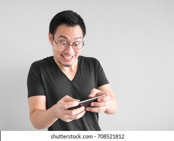 Happy Asian Man Is Winning The Mobile Game.