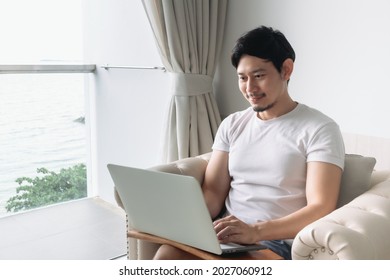 Happy Asian Man Work In The Hotel With Sea View. Staycation Concept.