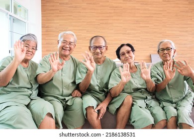 Happy Asian Men And Women Staying Together In Living Room In Nursing Home. Mental Health Care And Wellness In Senior Elder People.