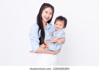 Happy Asian mom and her baby boy smiling together on white background. Good moment of Mother hug little baby smile and cheerful with love. Mother and family day concept - Powered by Shutterstock