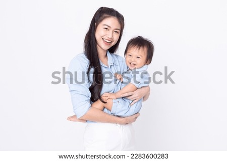 Happy Asian mom and her baby boy smiling together on white background. Good moment of Mother hug little baby smile and cheerful with love. Mother and family day concept