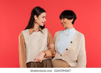 happy asian mother and daughter looking at each other isolated on coral - Powered by Shutterstock