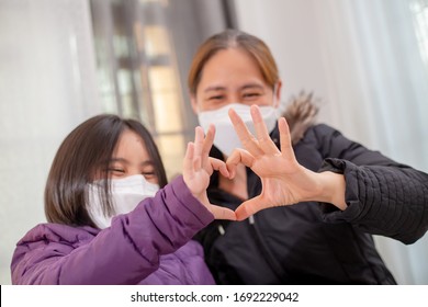 Happy Asian mother and daughter wearing face mask, Confidence family for virus protection - Powered by Shutterstock