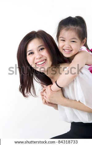 happy asian mother giving her daughter a piggyback ride