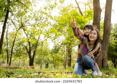 Happy Asian mother having fun with her son outdoors - Family and love concept. Mother’s day celebration. - Powered by Shutterstock