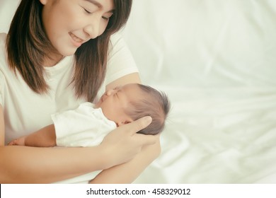Happy asian mother holding adorable child baby boy., soft color,soft focus