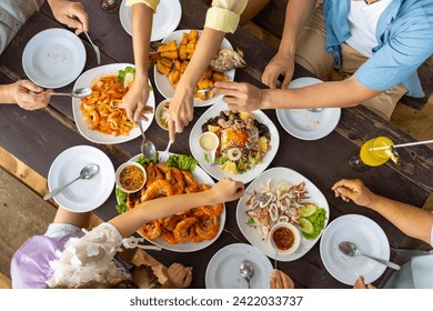 Happy Asian Multi-Generation family enjoy and fun spending time together having lunch eating seafood at beach restaurant during travel nature ocean at tropical island on summer holiday vacation.  - Powered by Shutterstock