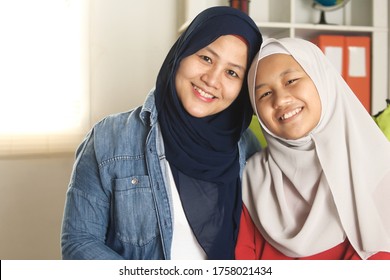 Happy Asian Muslim Mother And Daughter Spending Quality Time Together At Home, Teenage Girl With Mom, Motherhood Concept