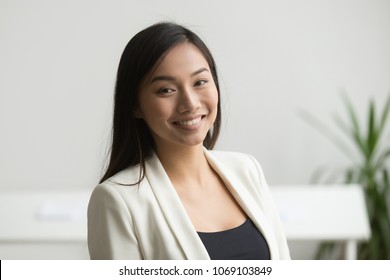 Happy Asian Office Worker In Formal Wear Smiling To Camera Posing For Company Business Catalogue, Making Portrait Photo. Confident Businesswoman Laughing With Bright Wide Smile