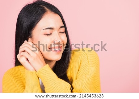 Happy Asian portrait beautiful cute young cheerful mixed race woman smile shy satisfied expression, studio shot isolated pink background, Thai female bashful pleasure put both hand on face, copy space