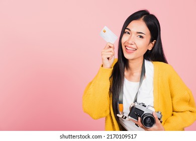 Happy Asian portrait beautiful young woman excited smiling photographer holding credit credit card bank and retro vintage photo camera ready travel isolated on pink background, tourism and vacation