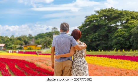 Happy asian retired couple relaxed in flower garden