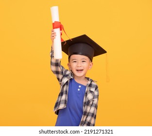 Happy Asian school kid graduate in graduation cap - Powered by Shutterstock