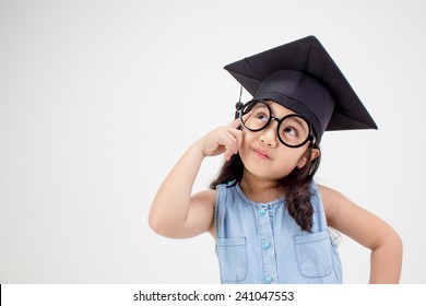 Happy Asian school kid graduate thinking with  graduation cap