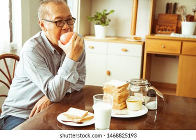 Happy Asian Senior Couple Cooking In Kitchen.