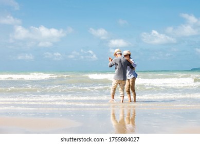 Happy  asian senior couple  dancing  on beach with blue sky background , Retirment travel  holiday healthy lifestyle Concept - Powered by Shutterstock