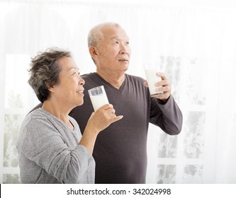 Happy Asian Senior Couple Drinking Milk