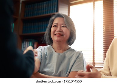 Happy Asian Senior Couple Feel Releif And Pleasant After Get The Advice About Family Financial Planning From Professional Financial Advisor At Home.