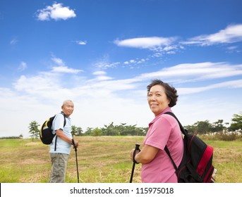 Happy Asian Senior Couple Hiking In The Nature