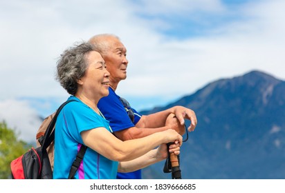 Happy Asian Senior Couple Hiking In Nature 