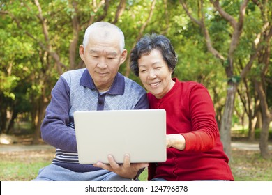 Happy Asian  Senior Couple With Laptop