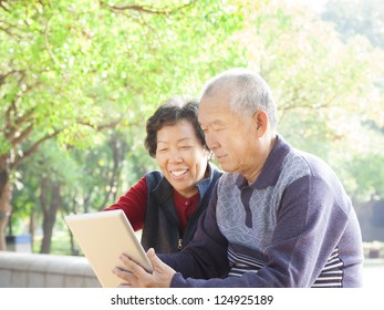 happy asian  Senior couple with tablet pc