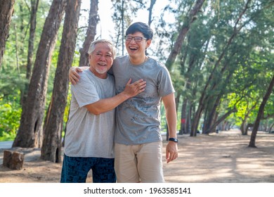 Happy Asian Senior Father And Adult Son Do Sport Exercising On The Beach Together In Summer Morning. Healthy Man With Retirement Elderly Father Relax And Enjoy Outdoor Lifestyle Activity On Vacation