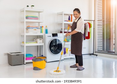 Happy Asian Senior Female Woman Using Mop To Clean Floor