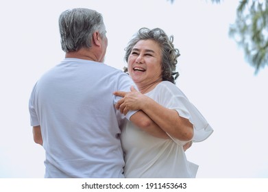 Happy asian senior retired couple, relax smiling elder man and woman enjoying with retired vacation at sea beach outdoor. Health care, Family outdoor lifestyle
