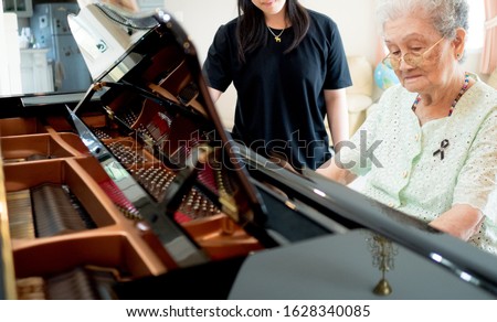 Happy asian senior woman learn to play the piano. Piano is a relax activity for elder.
