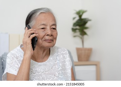 Happy Asian Senior Woman Using  Smartphone At Home. Grandparent Call To Family Member Using Mobile Phone Application.