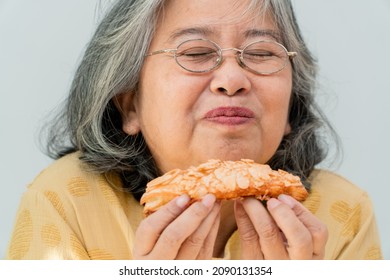 Happy Asian Senior Women Enjoying Eating Pie