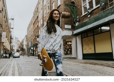 Happy Asian skate walking in city with yellow skateboard. Happy Asian women with skateboard walking down the street in the city. Hipster woman walking in the city with skateboard smiling. - Powered by Shutterstock