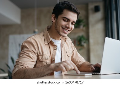 Happy asian student studying, learning language. Attractive business man working start up project in office. Portrait of successful Indian freelancer copywriter using laptop, typing on keyboard.  - Shutterstock ID 1638478717