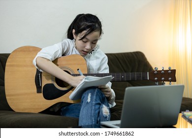 Happy Asian Teen Girl Is Practicing Composing A Song,trying To Write A New Music In Diary, Female People Relaxing Time, Hobby, Lifestyle, Inspiration, Creative Musician Enjoy Write Making Up A Lyrics