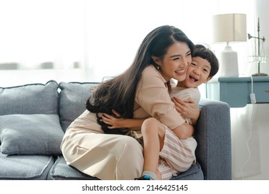 Happy Asian tender son hugging mother on mother's day during holiday celebration at home. - Shutterstock ID 2146425145