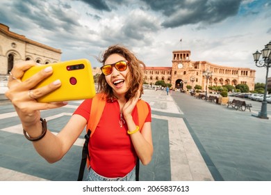 Happy Asian Tourist Woman Takes A Selfie Photograph For Her Travel Blog On Social Media Against The Background Of The Republic Square In Yerevan, Armenia
