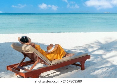 Happy Asian traveler woman relaxing on beach chair at tropical sandy beach Summer and vacation concept. Copy space - Powered by Shutterstock