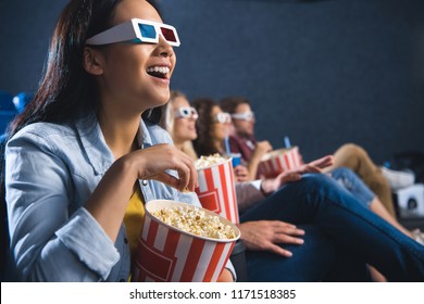 Happy Asian Woman In 3d Glasses With Popcorn Watching Movie In Cinema