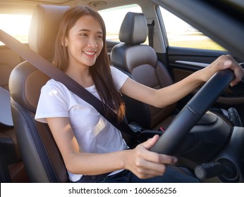  Happy Asian Woman In A Car.A Beautiful Woman Smiled In Her New Car. Car Insurance