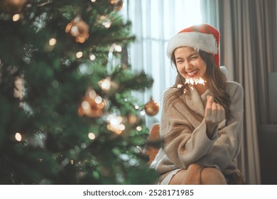 Happy asian woman celebrating Christmas and new year with sparkler fire. Concept of people and celebration - Powered by Shutterstock