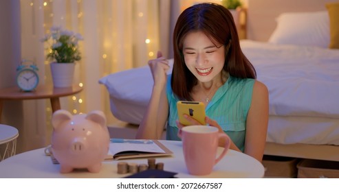 happy asian woman distributing family budget is managing domestic finances and she find something surprise about her finance at home - Shutterstock ID 2072667587