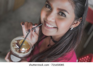 Happy Asian Woman Drinking Ice Tea With Lemon In Coffee Shop, Selective Focus On Face