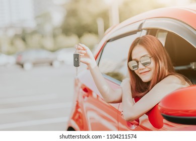 Happy Asian Woman Driver Holding Car Key In Her New Car